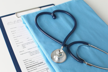 Stethoscope on a table with medical uniform