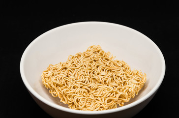 Isolated Instant Noodles in White ceramic bowl on Black background with clipping path