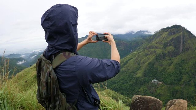 Active Hiker Man Takes Photo With Smartphone Of Mountain Top. 4K.