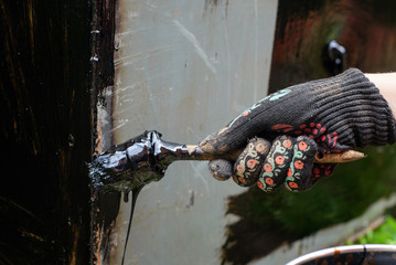 worker waterproofing metal construction