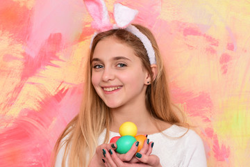 Fototapeta na wymiar happy easter girl in bunny ears with colorful painted eggs