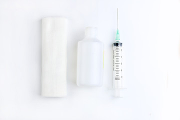 Medical bandage roll and disposable syringe on white background. Set