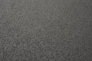 Fototapeta premium Hintergrund frisch verdichteter Asphalt als Schrägaufnahme - Background of freshly compacted asphalt as an inclined view