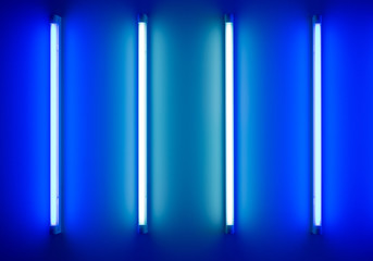 four neon tubes or lamps on the wall