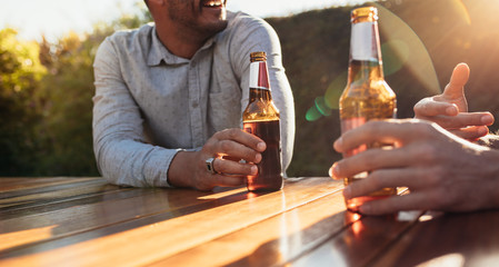 Couple having beers at outdoor party - Powered by Adobe
