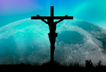 Jesus on the cross against super moon.  