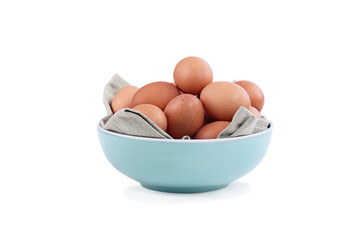 Isolated farm fresh organic brown chicken eggs from free range chickens in a blue bowl over a white background with light shadow. Clipping path included.