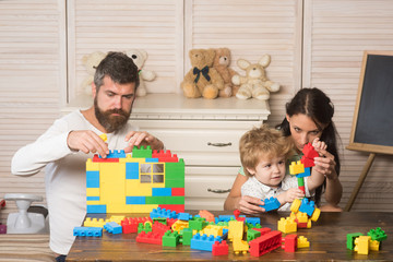 Family playing with plastic blocks. Family and childhood concept.