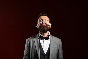 Macho in formal suit shaves beard. Businessman with funny grimace
