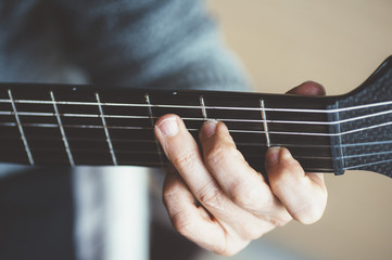 Elderly man playing carbon fiber guitar