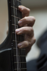 Elderly man playing carbon fiber guitar