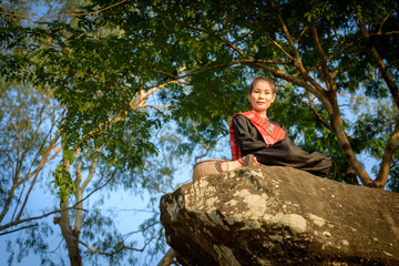 Phu Thai (Thai Language) girl stand on the rocks near the river.