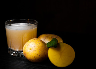 glass of potato juice on dark wooden background with copy space.