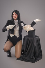 Beautiful woman magician with rabbit in hat