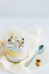 breakfast, oatmeal with banana and almons, chia,   in a glass