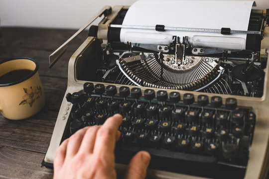 Man Writer Typing On A Old Typewriter. Journalism Report Concept