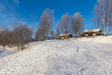 wooden houses on a mountain in winter