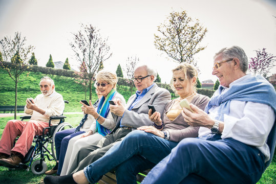 Senior people watching smartphones