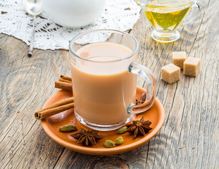 Masala Indian drink in the festival of Holi. Tea with milk and spices in a glass mug.