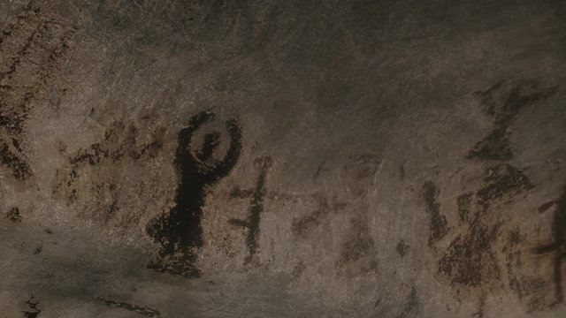 Slow pan on older than 7000 years decorations inside cave footage - Prehistoric wall paintings of Magura