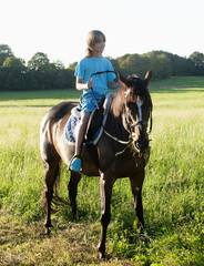 Boy in a Saddle of Horse Horseback Riding