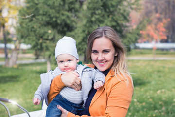 A mother playing with her little son in park