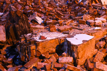 Pile of red bricks, illuminated at night by a street lamp