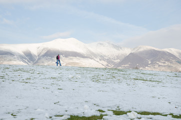 The Lake District, Keswick, England, 01/17/2016, Snowy field with snow covered mountains in the...