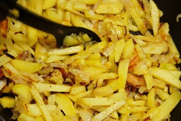 fried potatoes with onions on a pan