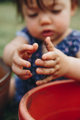 Child's Hands Playing in Garden Dirt