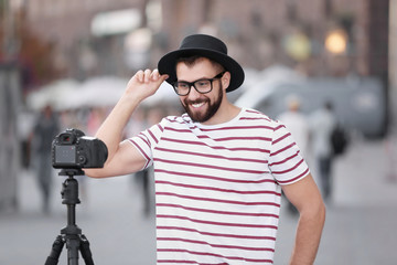 Young blogger recording video outdoors