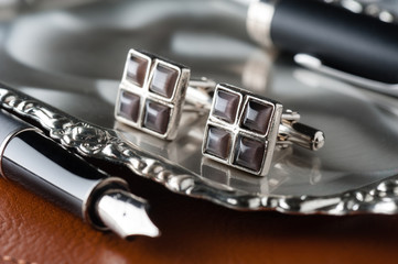 shiny cufflinks with gemstones