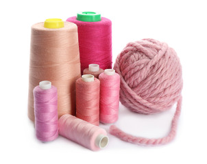 Pink threads of different shades on white background
