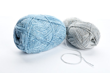 Colorful yarn bundles on white background
