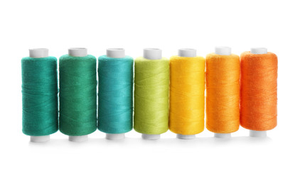 Many colorful threads on white background, top view