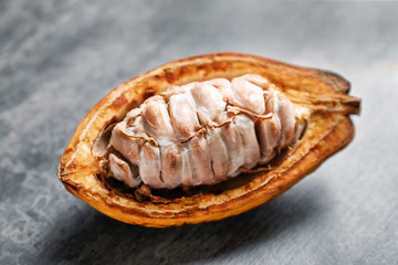 Cut cocoa pod on grey background, closeup