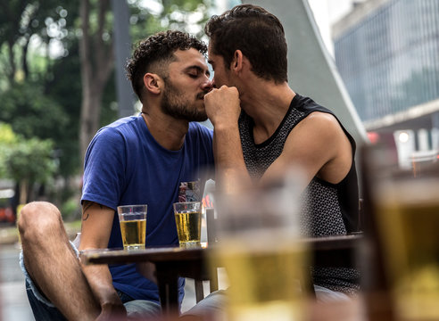 Gay Couple Drinking Beer In Street