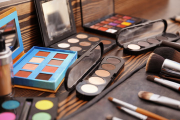 Fototapeta na wymiar Cosmetics and tools of professional makeup artist on dressing table
