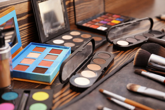 Cosmetics and tools of professional makeup artist on dressing table