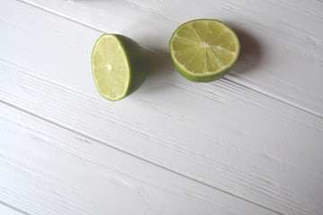 Lime on the white wooden background.