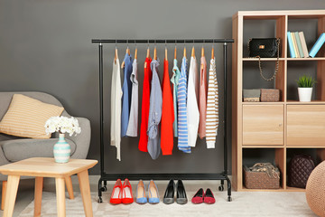 Rack with collection of clothes in dressing room