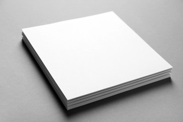 Blank sheets of paper on grey background. Mock up for design
