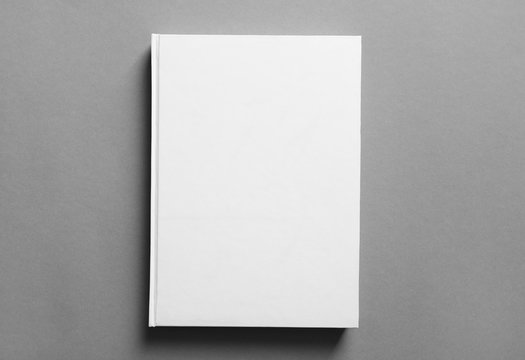 Book with blank cover on grey background. Mock up for design