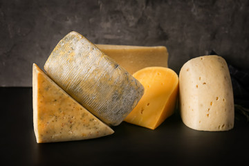 Different kinds of delicious cheese on table