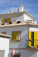 Typical white house with yellow windows in Portugal, Algarve. South coast line of Portugal. 