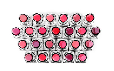 Lipsticks of different shades on white background