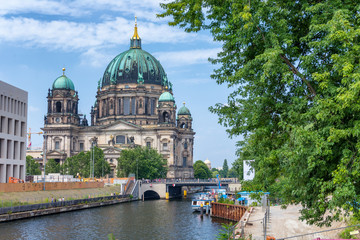 Fototapeta na wymiar BERLIN, GERMANY - JULY 24, 2016: City Cathedral along Spree river in summer. Berlin attracts 20 million people annually