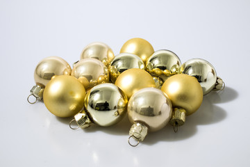 Gold glass christmas balls in a white background