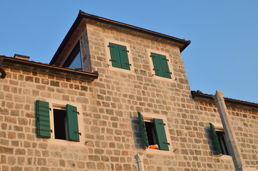 Obraz premium Coastal palace facade with green wooden jalousies in summer
