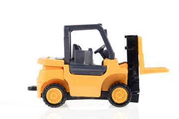 Forklift / Plastic toy forklift on white background.